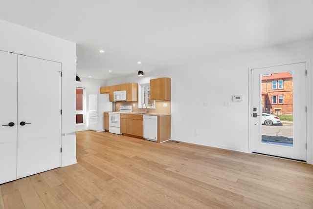 112 Mount Vernon St, Detroit, MI 48202 - kitchen with white appliances, a sink, light wood finished floors, light countertops, and recessed lighting