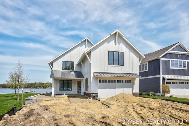 1351 Bayview Dr, Holland, MI 49423 - modern farmhouse featuring a standing seam roof, a garage, a water view, and metal roof