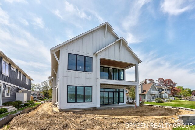 1351 Bayview Dr, Holland, MI 49423 - back of property featuring board and batten siding and a residential view
