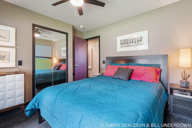 carpeted bedroom with ceiling fan and a closet