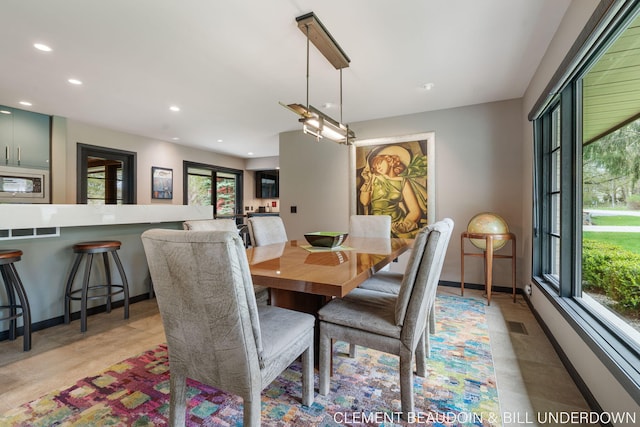 dining room with baseboards and recessed lighting
