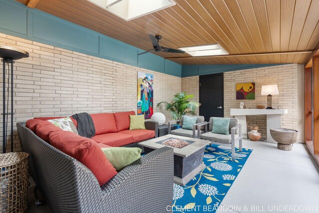 living area featuring brick wall, wood ceiling, and finished concrete floors