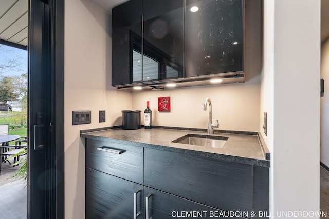 kitchen with a sink, dark countertops, and modern cabinets