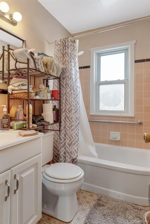bathroom featuring toilet, vanity, shower / bath combination with curtain, and tile patterned flooring