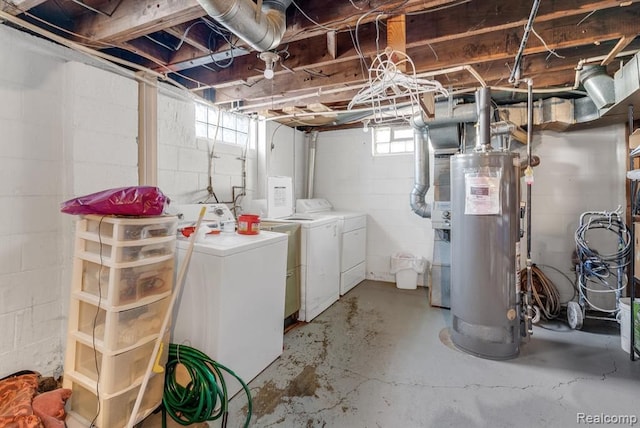 basement with water heater and washing machine and dryer