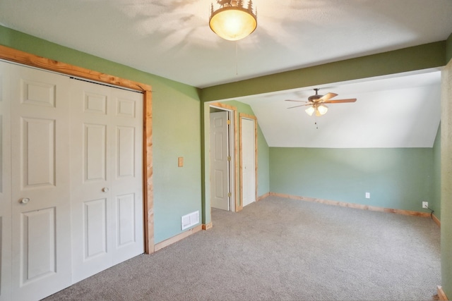 additional living space featuring carpet floors, lofted ceiling, baseboards, and ceiling fan