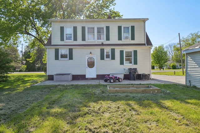 view of front of house with a front lawn and central AC