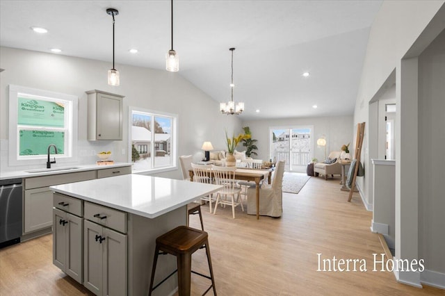 3772 Ambrosia Dr SW Unit 25, Grand Rapids, MI 49534 - kitchen with gray cabinets, a sink, dishwasher, light countertops, and a breakfast bar area
