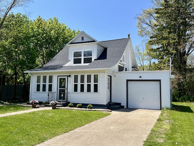 109 S Lake Ave, Spring Lake, MI 49456 - view of front of house featuring a garage, concrete driveway, a front yard, and roof with shingles