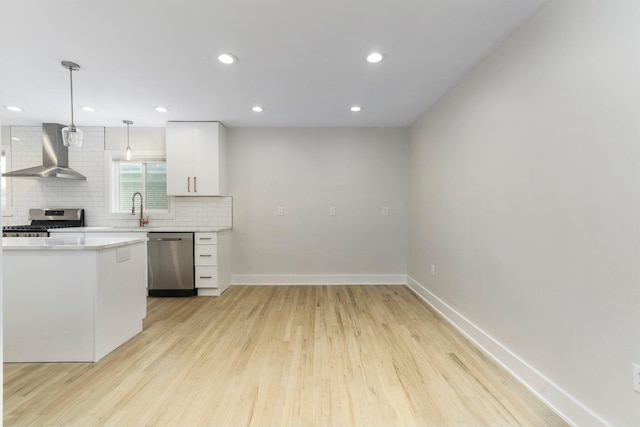 25720 Southwood Dr, Southfield, MI 48075 - kitchen featuring wall chimney exhaust hood, stainless steel appliances, light countertops, tasteful backsplash, and light wood-style flooring