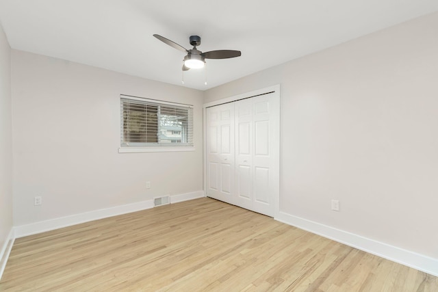 25720 Southwood Dr, Southfield, MI 48075 - unfurnished bedroom with light wood-style flooring, baseboards, a closet, and a ceiling fan