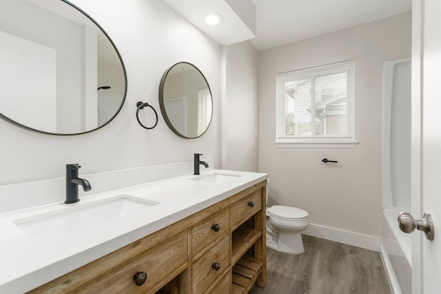 25720 Southwood Dr, Southfield, MI 48075 - full bath featuring wood finished floors, toilet, baseboards, and double vanity
