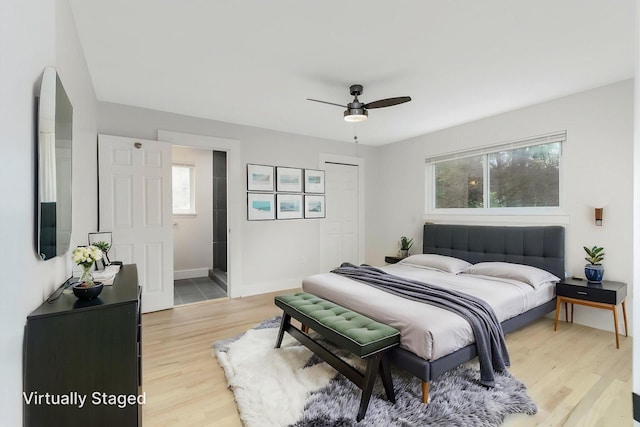 25720 Southwood Dr, Southfield, MI 48075 - bedroom featuring multiple windows, light wood-style flooring, baseboards, and ceiling fan