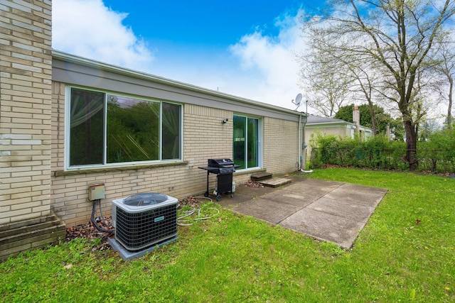 25720 Southwood Dr, Southfield, MI 48075 - back of property featuring brick siding, a patio area, central AC, and entry steps