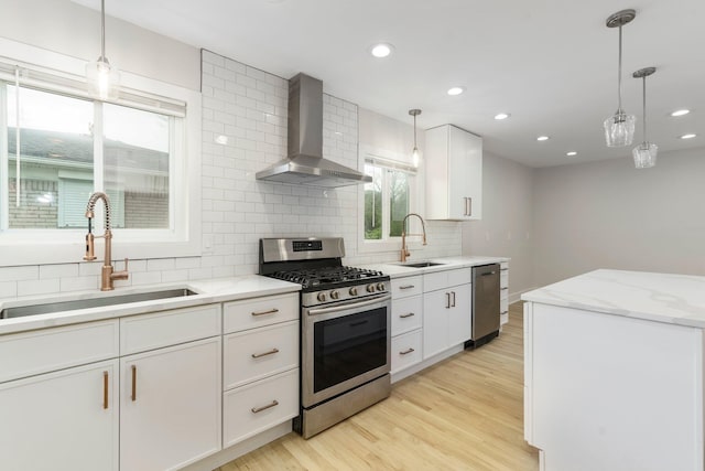 25720 Southwood Dr, Southfield, MI 48075 - kitchen featuring stainless steel appliances, wall chimney range hood, a sink, backsplash, and recessed lighting