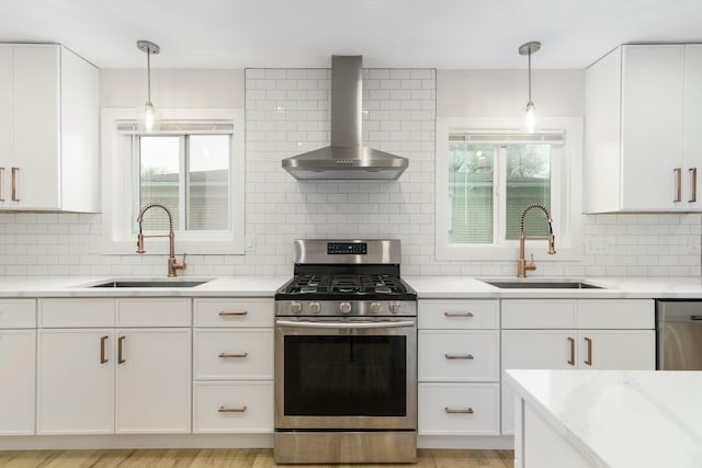 25720 Southwood Dr, Southfield, MI 48075 - kitchen featuring appliances with stainless steel finishes, wall chimney exhaust hood, a sink, and decorative backsplash