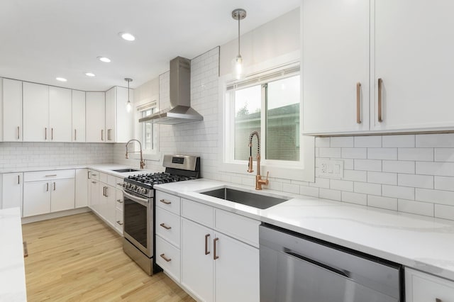 25720 Southwood Dr, Southfield, MI 48075 - kitchen with stainless steel appliances, wall chimney range hood, a sink, light stone counters, and recessed lighting