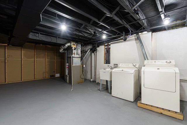 25720 Southwood Dr, Southfield, MI 48075 - unfinished basement featuring washer and dryer, heating unit, and a sink