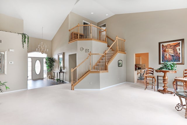 61450 Wedgewood Dr, Washington, MI 48094 - carpeted entrance foyer featuring high vaulted ceiling, stairs, baseboards, and a chandelier