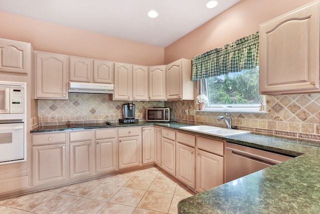 61450 Wedgewood Dr, Washington, MI 48094 - kitchen featuring stainless steel appliances, under cabinet range hood, a sink, dark countertops, and light tile patterned floors