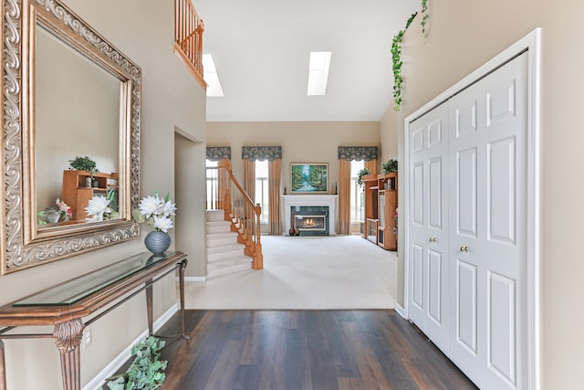 61450 Wedgewood Dr, Washington, MI 48094 - entrance foyer featuring stairs, high vaulted ceiling, a fireplace, dark wood-type flooring, and a skylight