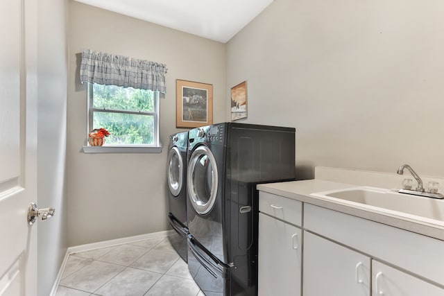 61450 Wedgewood Dr, Washington, MI 48094 - clothes washing area with washing machine and dryer, cabinet space, baseboards, and light tile patterned floors