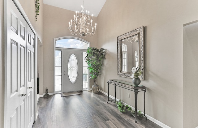 61450 Wedgewood Dr, Washington, MI 48094 - foyer entrance with high vaulted ceiling, baseboards, wood finished floors, and a chandelier