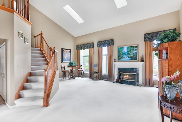 61450 Wedgewood Dr, Washington, MI 48094 - carpeted living area featuring high vaulted ceiling, a skylight, stairs, a high end fireplace, and baseboards