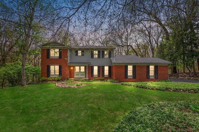 5445 Washakie Trl, Brighton, MI 48116 - colonial home with a front yard, brick siding, and asphalt driveway