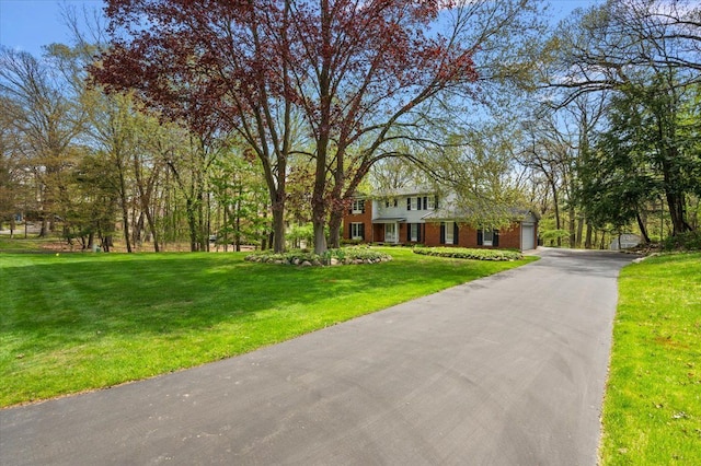 5445 Washakie Trl, Brighton, MI 48116 - view of front facade featuring a front yard, asphalt driveway, and an attached garage