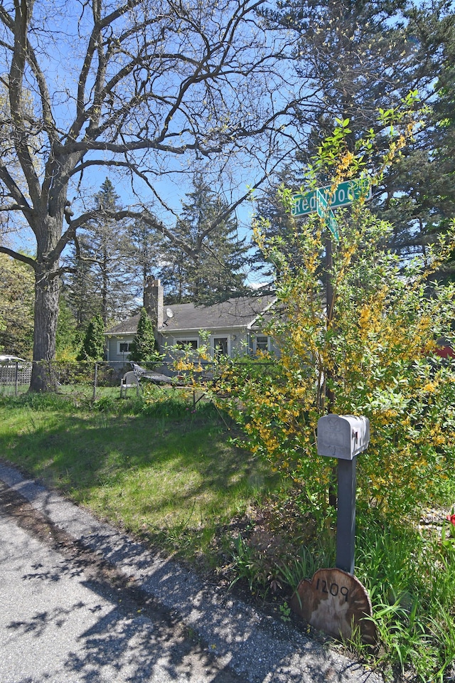 1209 Applewood Dr, White Lake, MI 48386 - view of front of house featuring a chimney and fence