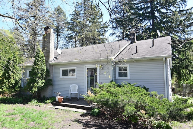 1209 Applewood Dr, White Lake, MI 48386 - back of house with a chimney