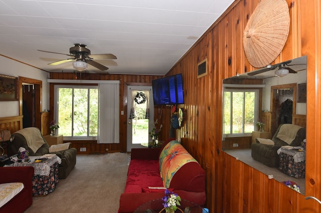 1209 Applewood Dr, White Lake, MI 48386 - living room featuring plenty of natural light, carpet floors, wooden walls, ceiling fan, and crown molding