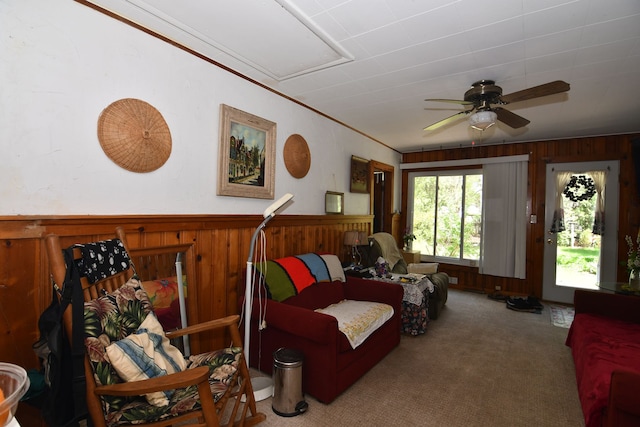 1209 Applewood Dr, White Lake, MI 48386 - carpeted living room featuring wood walls, a ceiling fan, and wainscoting
