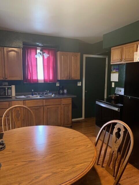 2983 Worden St, Norton Shores, MI 49444 - kitchen with a sink, light wood finished floors, and dark countertops