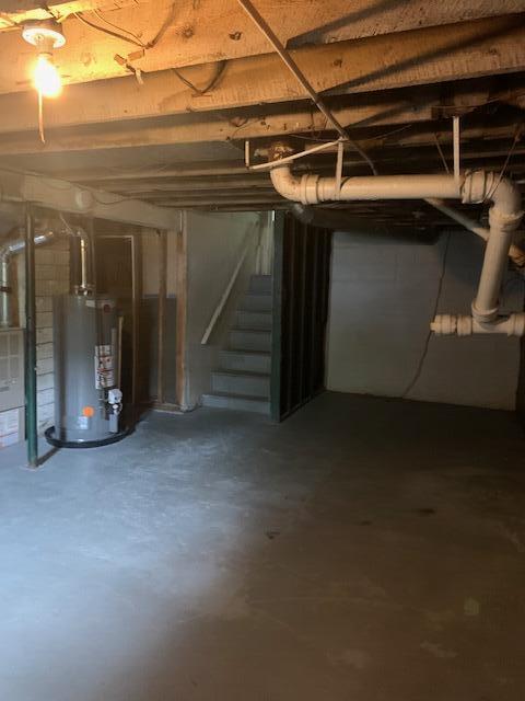 2983 Worden St, Norton Shores, MI 49444 - unfinished basement featuring water heater and stairway