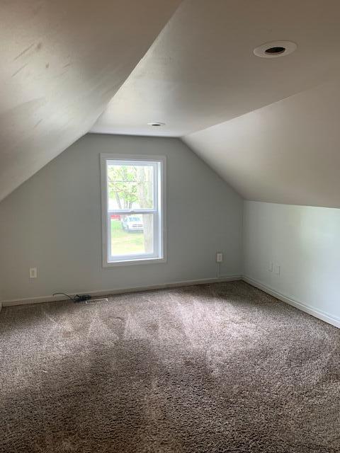2983 Worden St, Norton Shores, MI 49444 - additional living space featuring carpet, vaulted ceiling, and baseboards