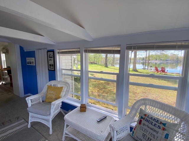 sunroom / solarium featuring a water view and lofted ceiling