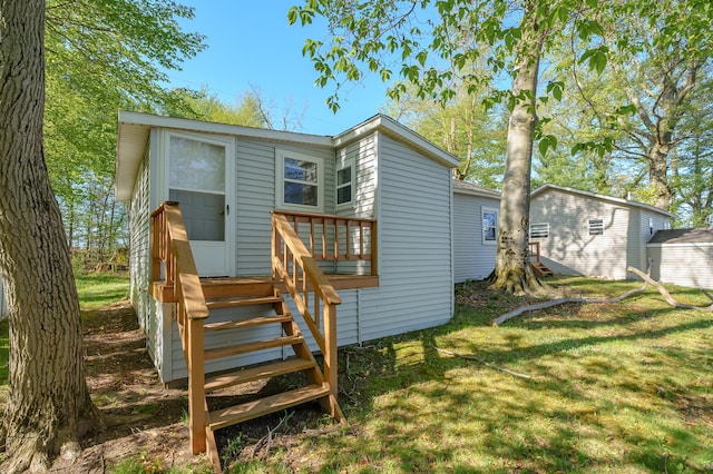 rear view of house with a yard