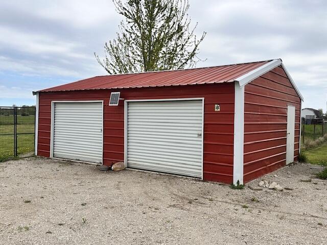 1120 W Montgomery Rd, Camden, MI 49232 - detached garage with fence