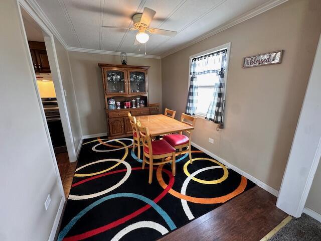 1120 W Montgomery Rd, Camden, MI 49232 - dining room featuring ceiling fan, ornamental molding, and baseboards