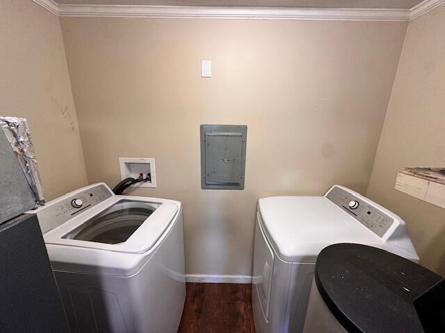 1120 W Montgomery Rd, Camden, MI 49232 - clothes washing area with washing machine and clothes dryer, electric panel, wood finished floors, ornamental molding, and baseboards