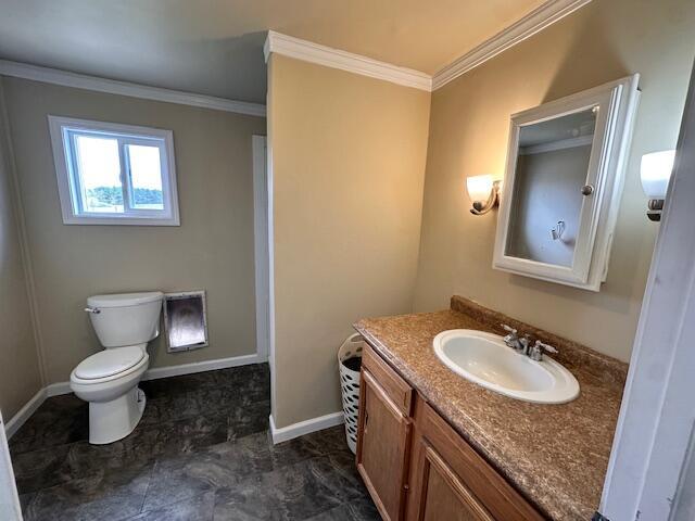 1120 W Montgomery Rd, Camden, MI 49232 - bathroom featuring ornamental molding, vanity, toilet, and baseboards