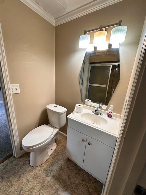1120 W Montgomery Rd, Camden, MI 49232 - full bathroom with a shower stall, vanity, ornamental molding, toilet, and baseboards