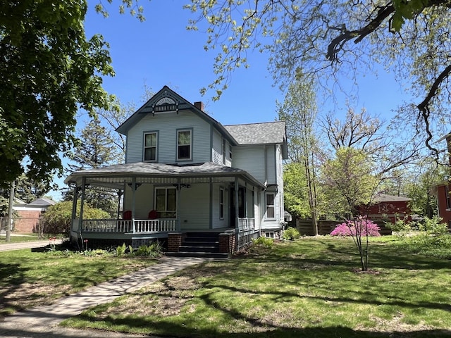504 Stuart Ave, Kalamazoo, MI 49007 - victorian-style house with covered porch, roof with shingles, and a chimney