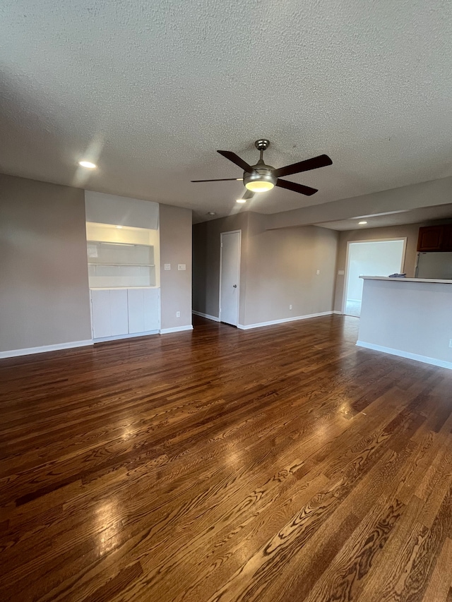 31124 Windsor St, Westland, MI 48185 - unfurnished living room with a textured ceiling, baseboards, a ceiling fan, and dark wood finished floors