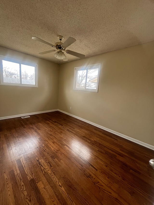 31124 Windsor St, Westland, MI 48185 - spare room featuring a textured ceiling, ceiling fan, plenty of natural light, dark wood-style floors, and baseboards
