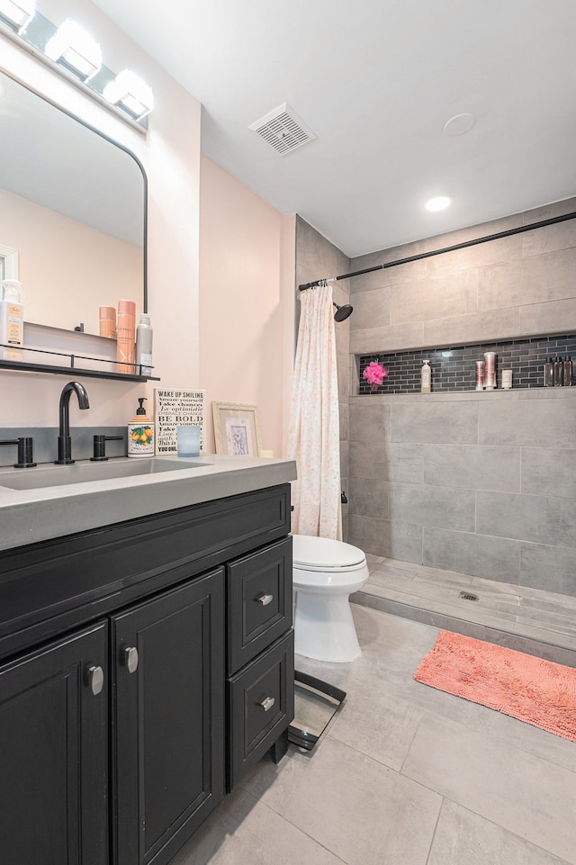full bath featuring tiled shower, toilet, vanity, tile patterned floors, and recessed lighting