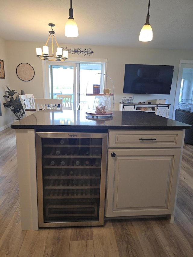 567 Angler Ave, Coldwater, MI 49036 - kitchen featuring beverage cooler, dark countertops, a chandelier, and wood finished floors
