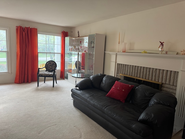 carpeted living area featuring a brick fireplace